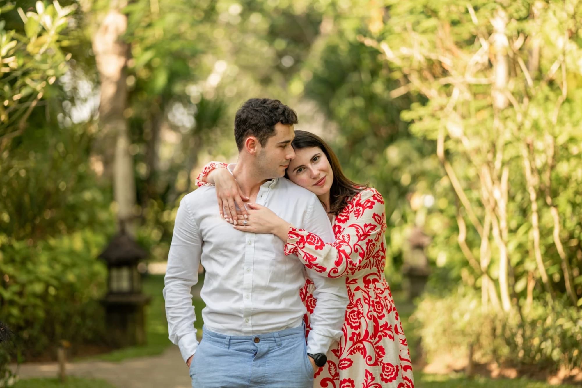 Bríd resting her head on Barry's shoulder in a garden
